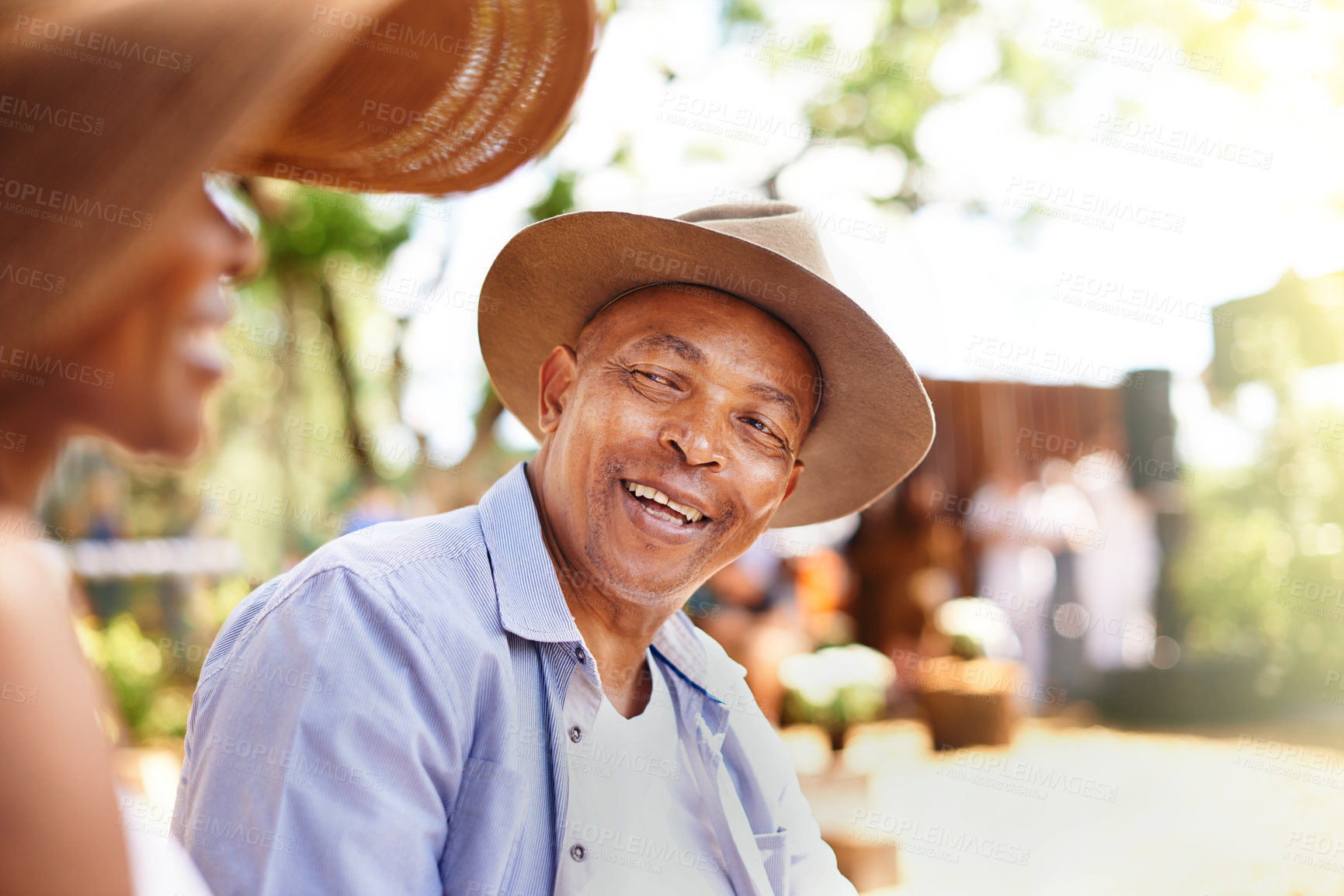 Buy stock photo Man, woman and talking in outdoor or together with smile, conversation with hat in sunshine. Mature, couple and communication for wellness or bonding in nature, happy for summer in Guatemala