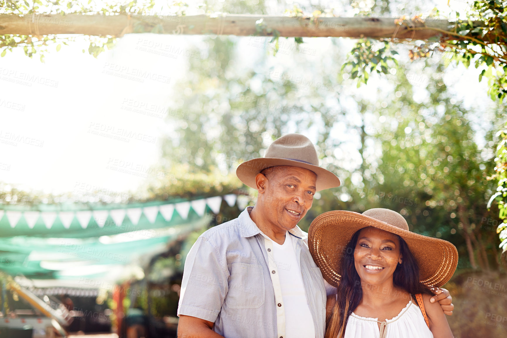 Buy stock photo Black couple, portrait and hug with smile at outdoor market for vacation, traveling or connection. Mature man, woman and happiness in Argentina with embrace in summer backyard, exploring or garden