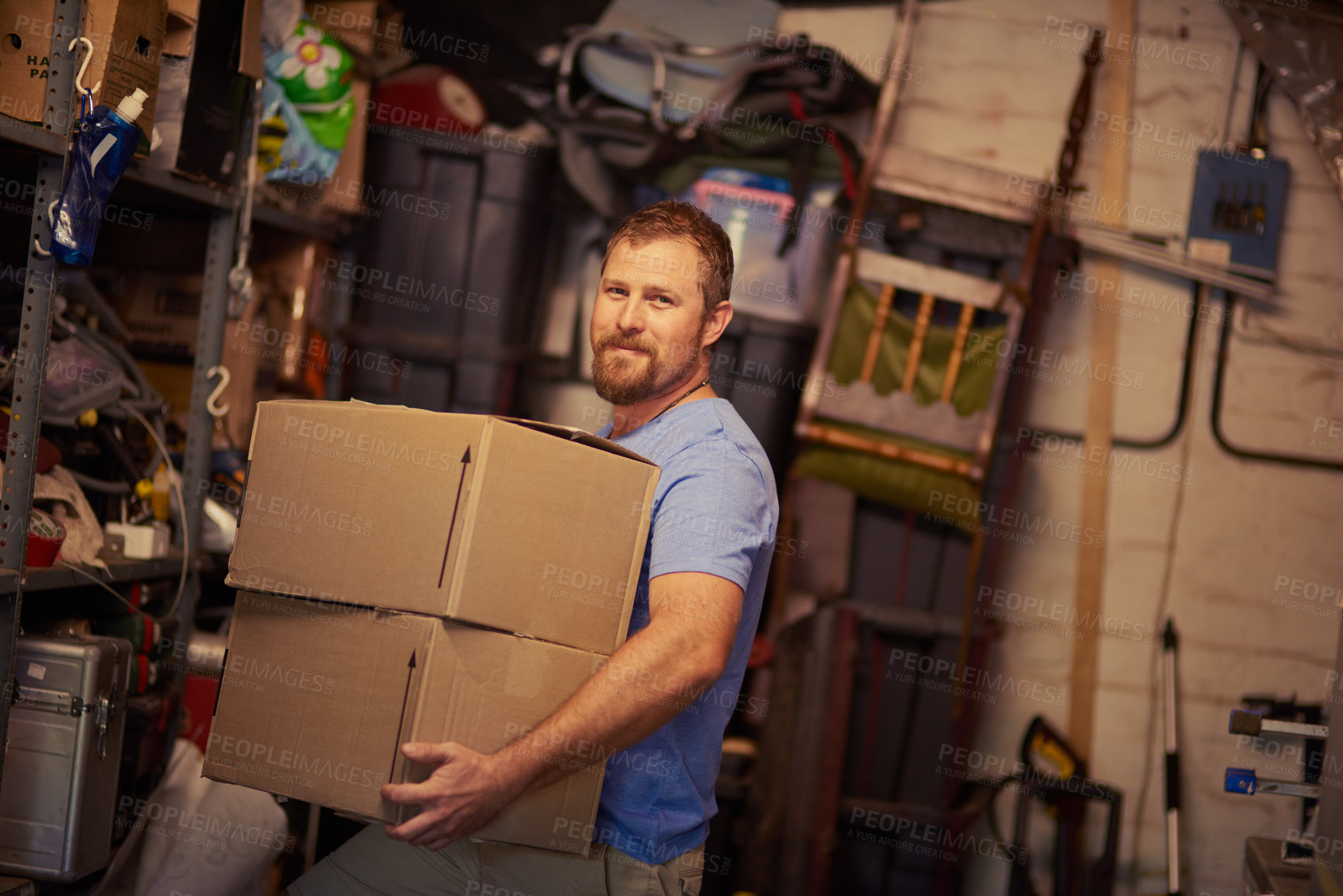 Buy stock photo Portrait of a young man packing boxes
