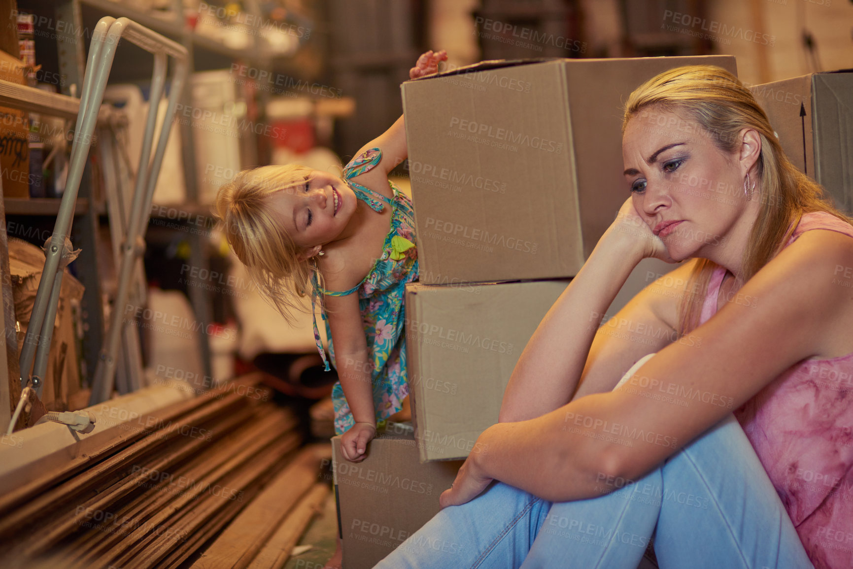 Buy stock photo Cropped shot of a little girl trying to cheer her mother up  while they move boxes
