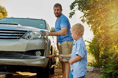 Buy stock photo Cropped shot of a father and son washing a car together