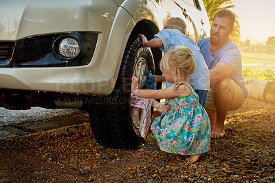 Buy stock photo Shot of a family washing their car together