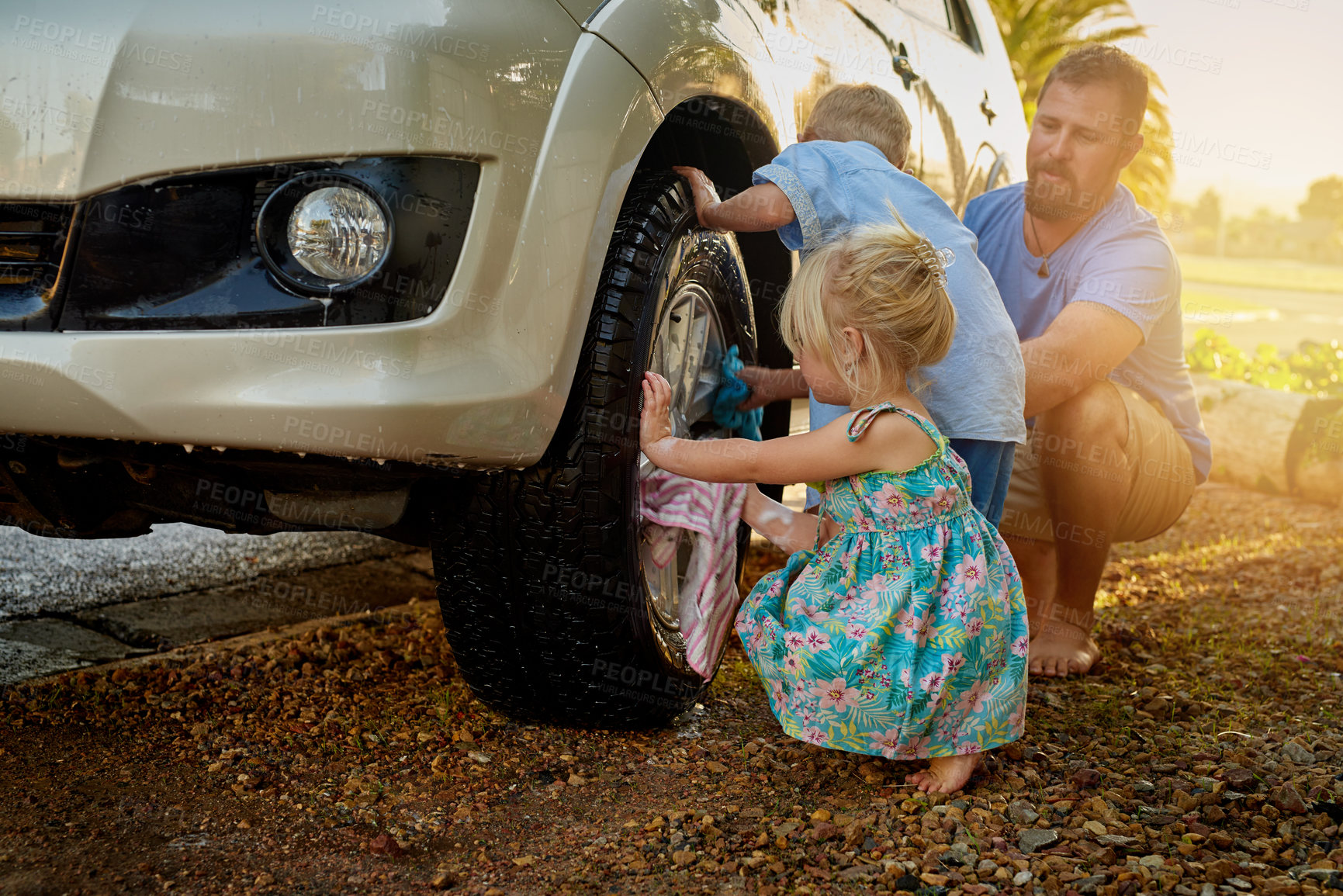 Buy stock photo Shot of a family washing their car together