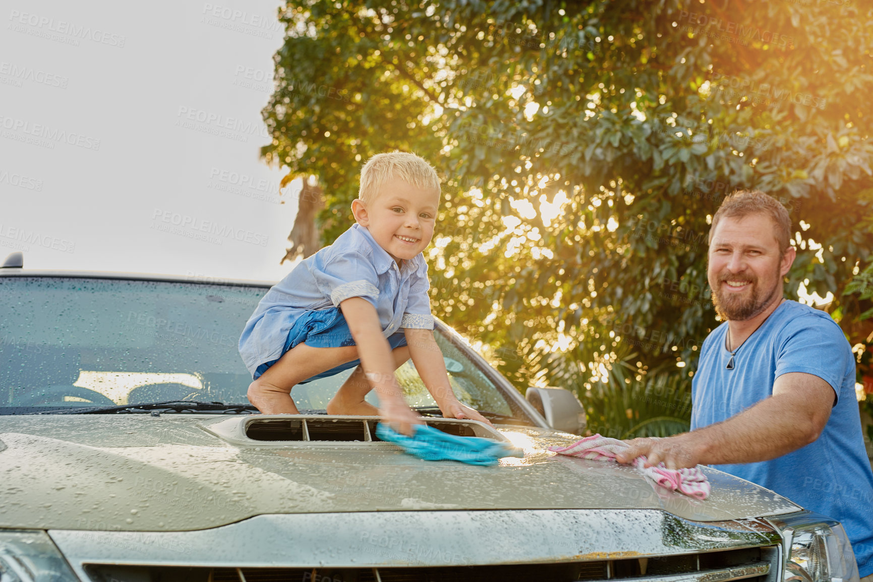 Buy stock photo Outdoors, man and kid with cleaning car in nature for maintenance, teamwork and childhood development. Dad, boy and child in portrait with washing vehicle for teaching, hygiene and help in parenthood