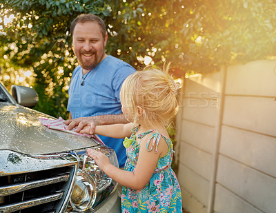 Buy stock photo Cropped shot of a father and daughter washing a car together
