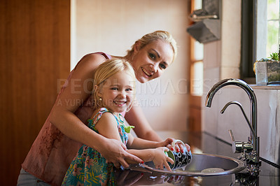 Buy stock photo Portrait of a mother and daughter washing dishes together