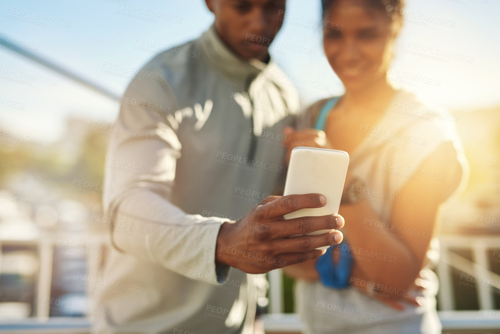 Buy stock photo Shot of a young sporty couple taking a photo together with a cellphone