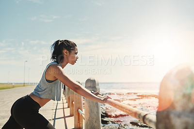 Buy stock photo Shot of a young sporty woman exercising outside
