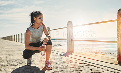 Buy stock photo Water, fitness and woman outdoor for relax, break or rest for wellness at beach promenade. Bottle, runner or tired athlete with liquid for hydration after exercise, sport or thinking of healthy body