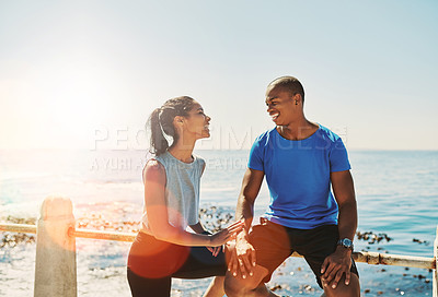 Buy stock photo Shot of a young sporty couple out for a run together