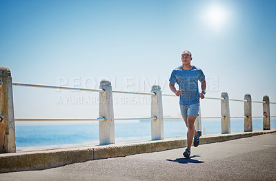 Buy stock photo Shot of a young sporty man running outside