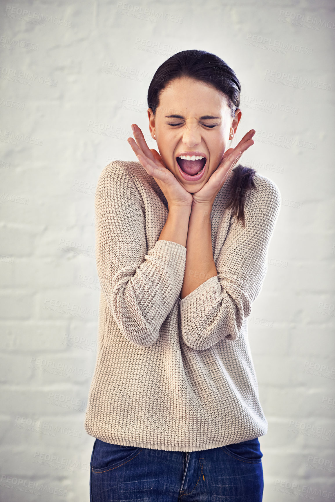 Buy stock photo Shot of a young woman looking shocked and shouting