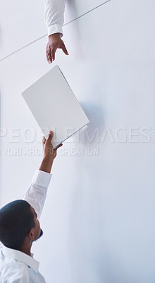 Buy stock photo Documents, exchange and hands with business man passing file to colleague in office for assistance. Help, reach and paper with employee giving folder to coworker on white wall background in workplace