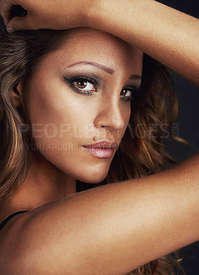 Buy stock photo Cropped shot of a beautiful young woman posing against a black background