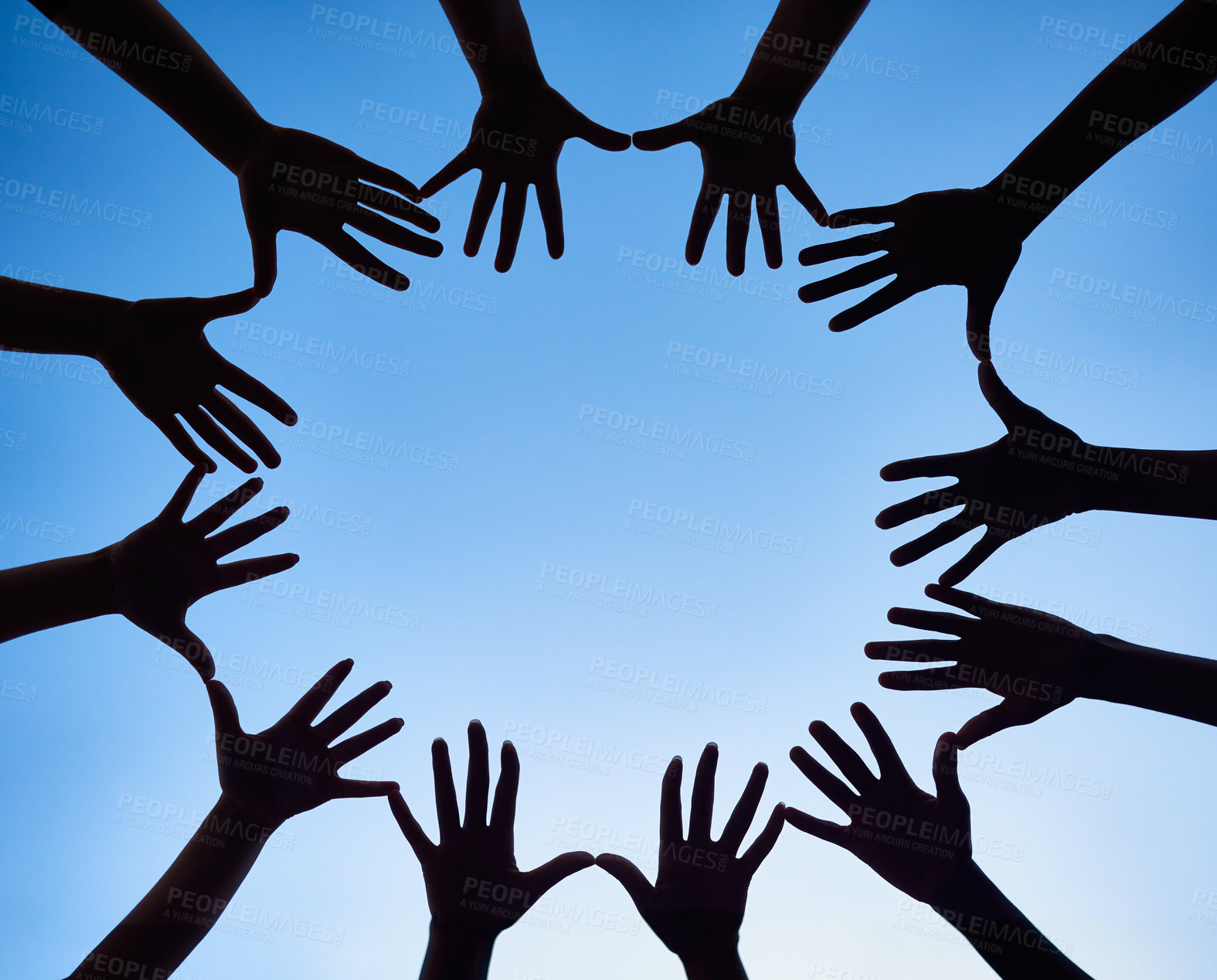 Buy stock photo Low angle shot of hands forming a circle against a bright blue sky