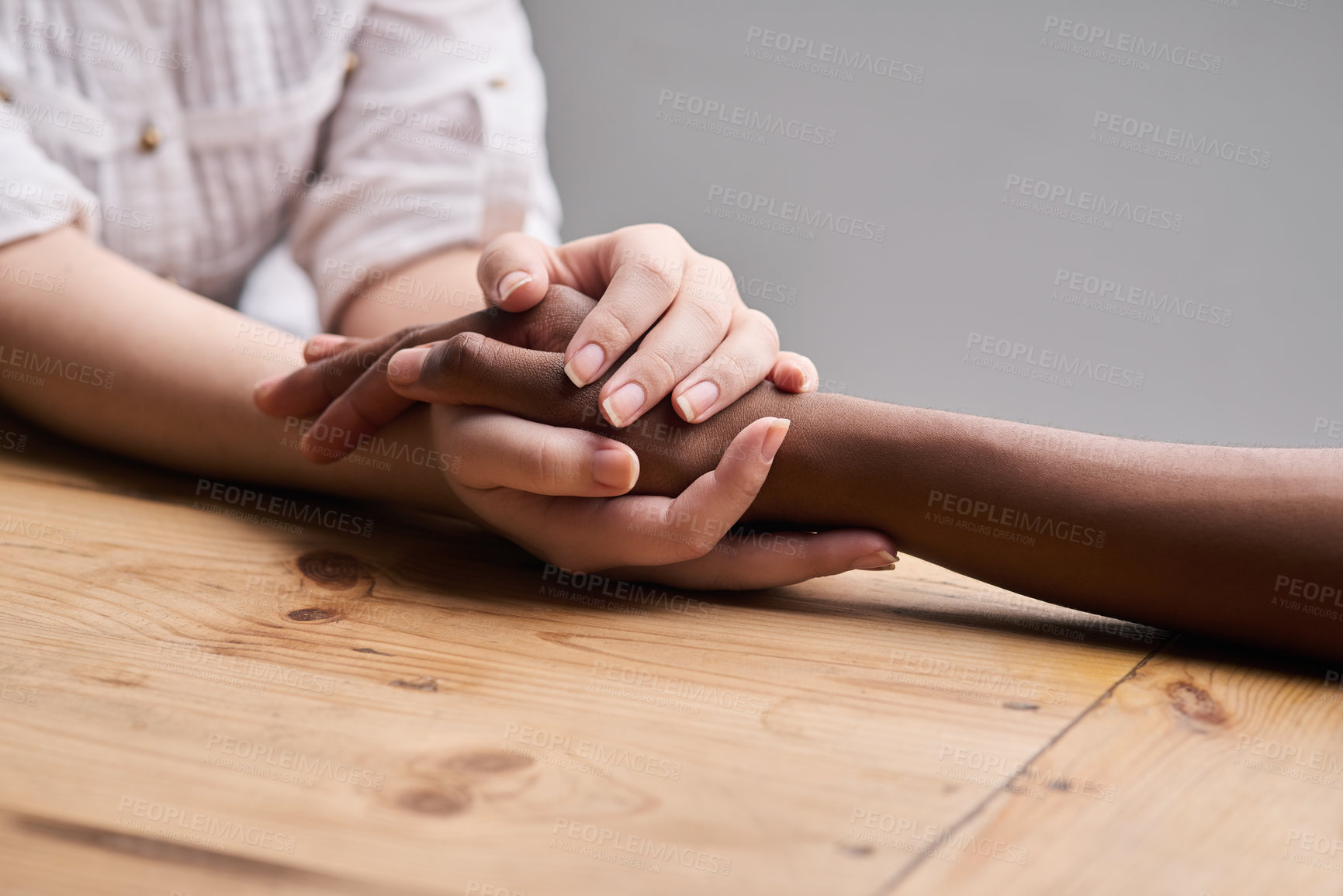 Buy stock photo Support, comfort and people holding hands for empathy, love and trust together. Help, table and diversity with a helping hand from life coach, care of friends and showing compassion for mental health