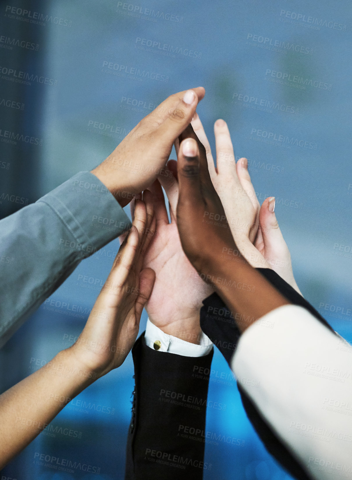 Buy stock photo Shot of a group of hands reaching up together