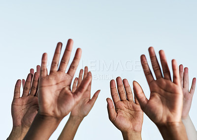 Buy stock photo Shot of a group of hands reaching up against a white background