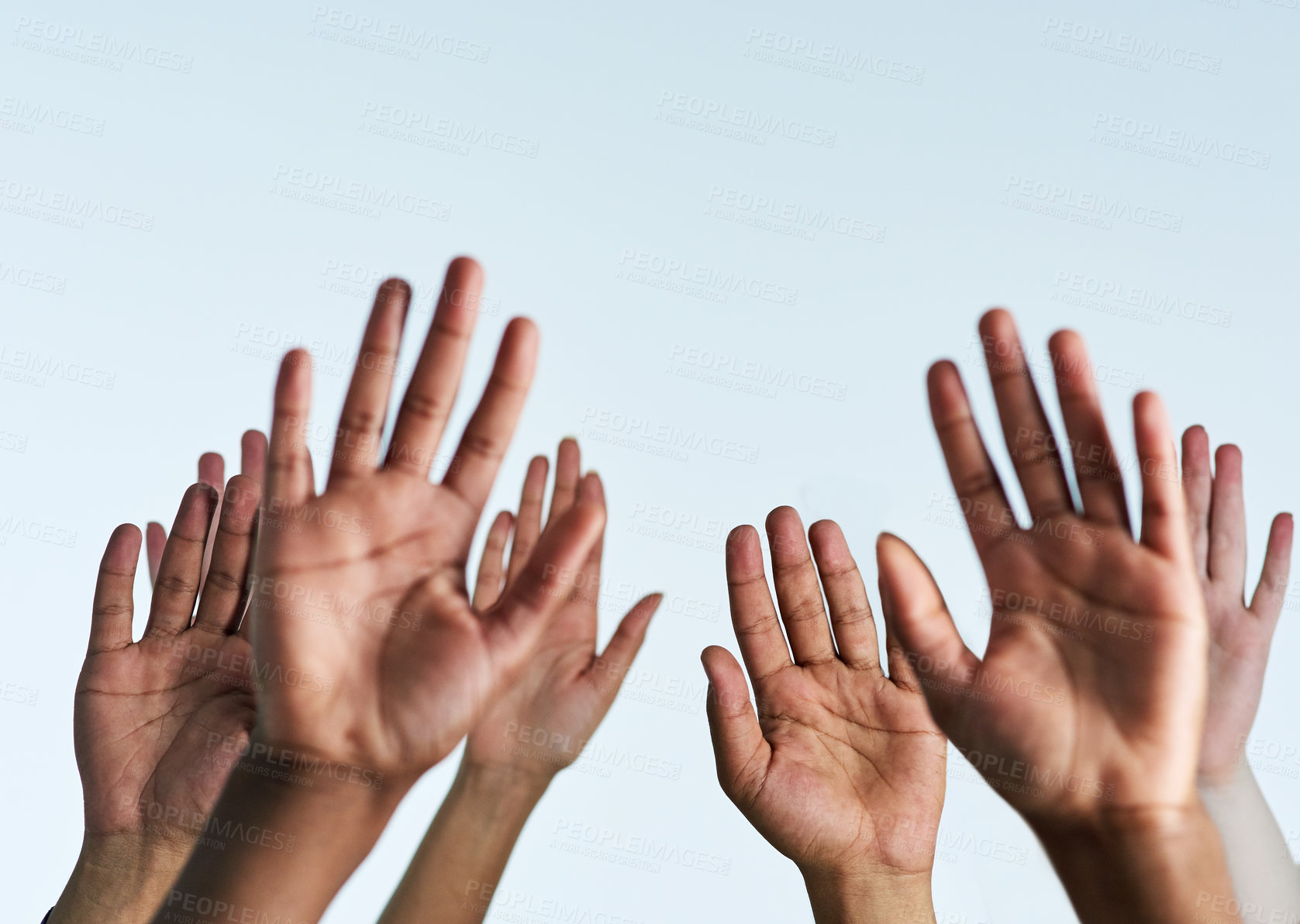 Buy stock photo Shot of a group of hands reaching up against a white background