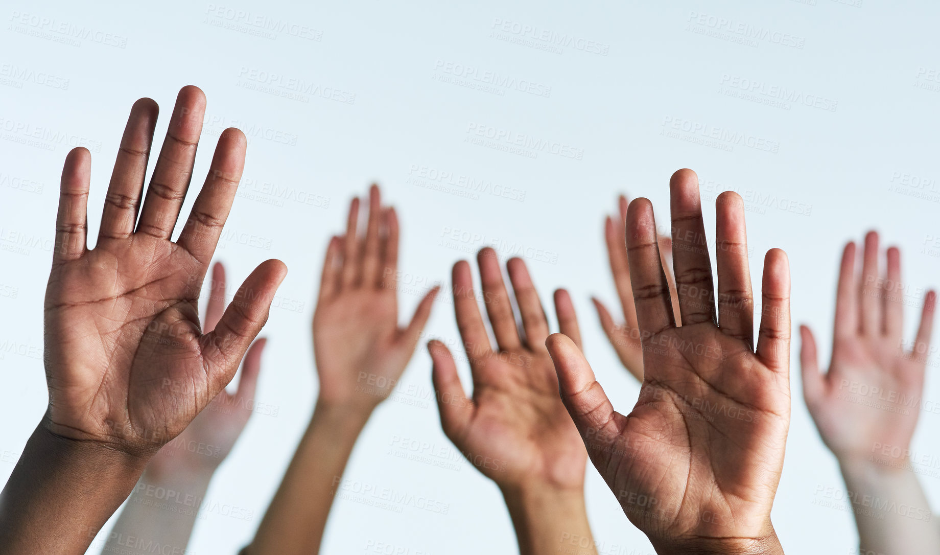 Buy stock photo Shot of a group of hands reaching up against a white background