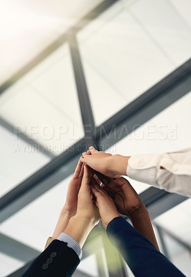 Buy stock photo Shot of a group of people putting their hands up together