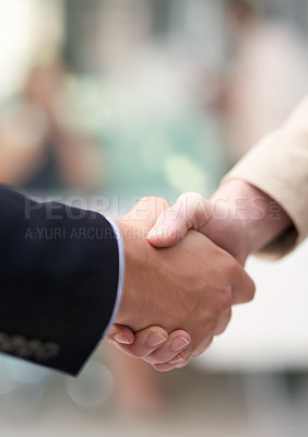 Buy stock photo Shot of a coworkers shaking hands in an office
