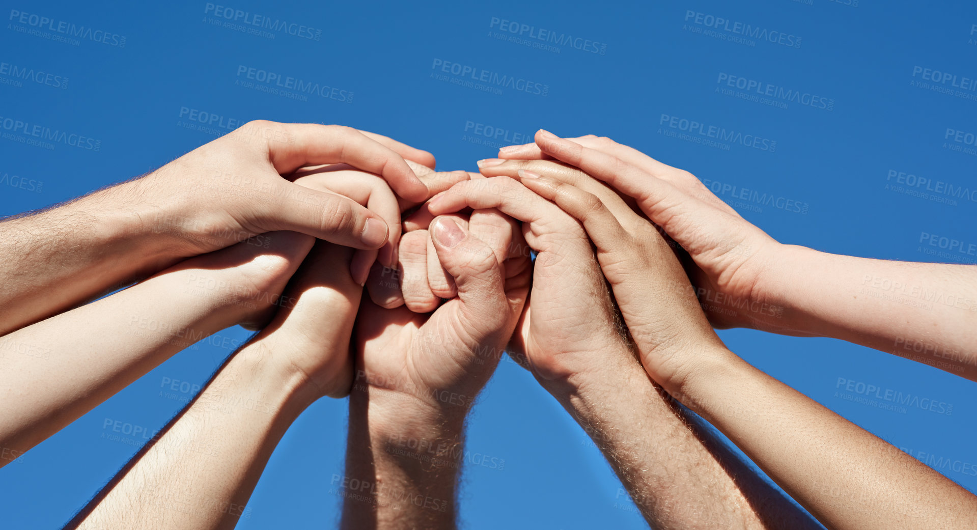 Buy stock photo Cropped shot of a group of hands holding on to each other