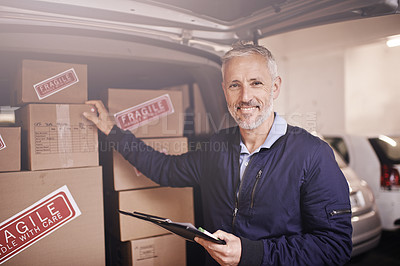 Buy stock photo Portrait of a mature delivery man standing next to a van packed with boxes