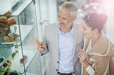 Buy stock photo Shot of a couple window shopping in a mall