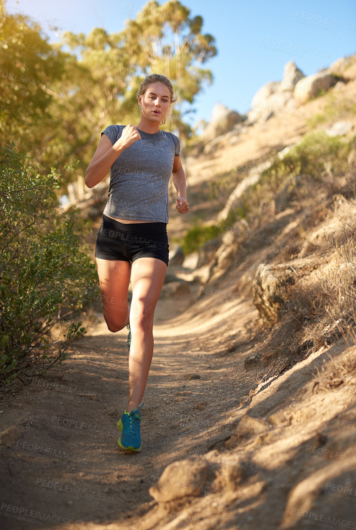 Buy stock photo Shot of a young woman out for a trail run