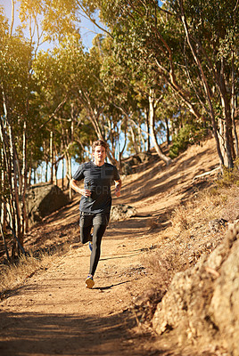 Buy stock photo Shot of a young man out for a trail run