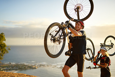 Buy stock photo Shot of a young couple out mountain biking