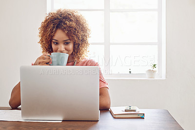 Buy stock photo Shot of a designer having coffee while working on her laptop