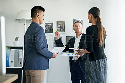 Buy stock photo Cropped shot of three colleagues working in the office