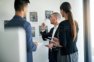 Buy stock photo Cropped shot of three colleagues working in the office