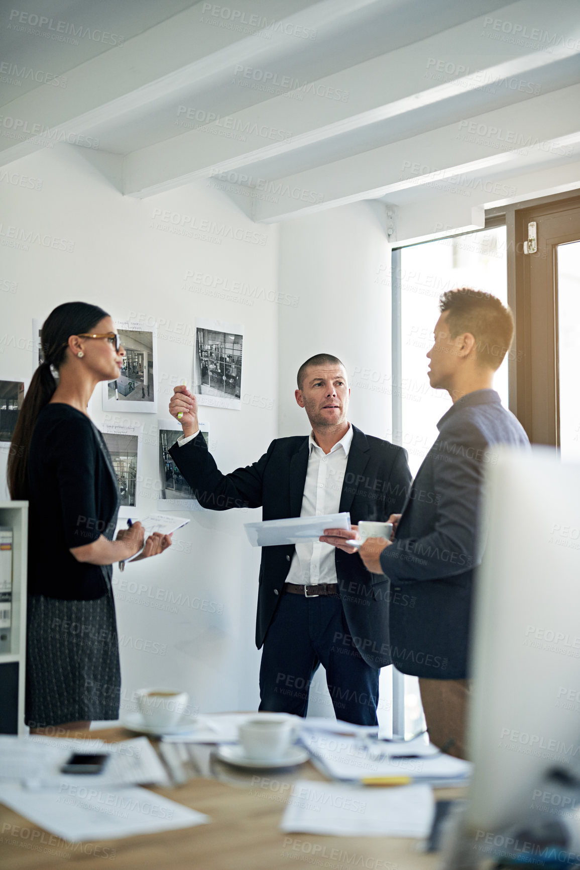 Buy stock photo Cropped shot of three colleagues working in the office