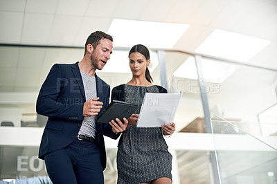 Buy stock photo Cropped shot of two colleagues walking together in the office