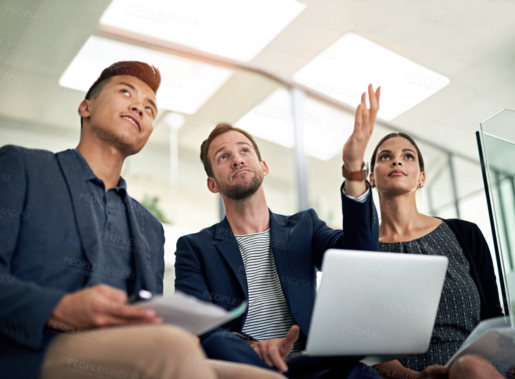 Buy stock photo Cropped shot of three colleagues working in the office