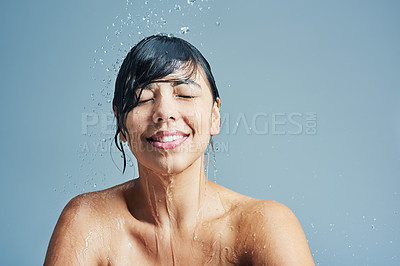 Buy stock photo Shower, washing and face of woman with water in studio on blue background for wellness, cleaning and grooming. Skincare, beauty mockup and happy female person for hygiene, hydration and self care