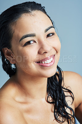 Buy stock photo Portrait of a young woman with wet hair against a blue background