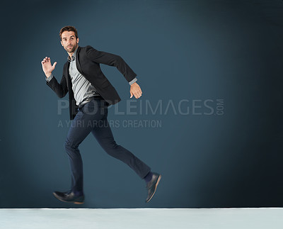 Buy stock photo Business, man and running in studio for hurry to workplace, corporate exercise and time management. Entrepreneur, serious and active for fast sprint to appointment or schedule and rushing with mockup