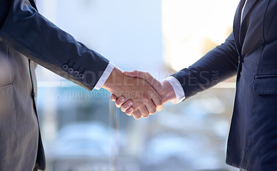 Buy stock photo Shot of two unidentifiable businessmen shaking hands in the office