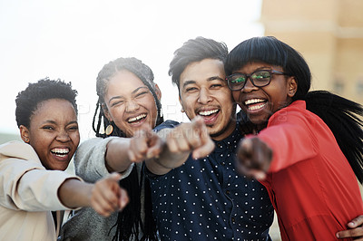 Buy stock photo Portrait of a group of happy students pointing toward the camera