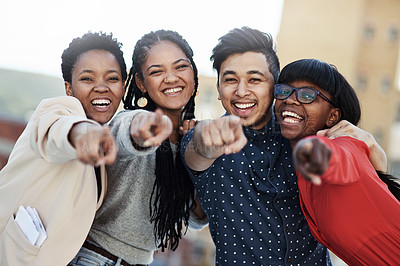 Buy stock photo Portrait of a group of happy students pointing toward the camera