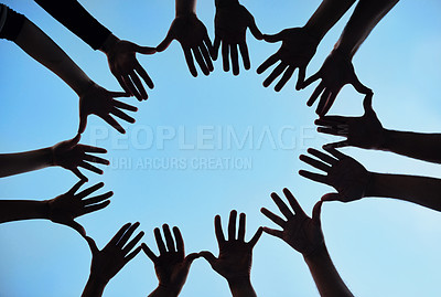 Buy stock photo Silhouetted shot of a group of unidentifiable people making a star shape with their hands