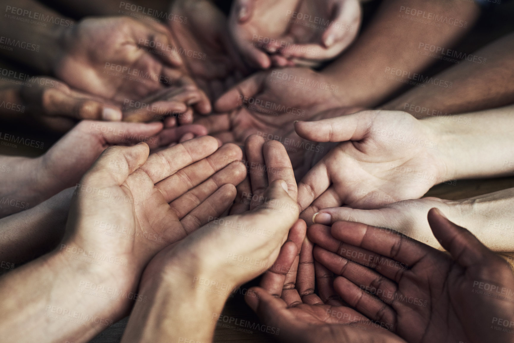 Buy stock photo Cropped shot of a large group of unidentifiable people cupping their hands together