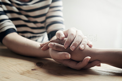 Buy stock photo Shot of an unidentifiable woman consoling her friend by holding her hand