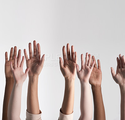 Buy stock photo Shot of a diverse group of unidentifiable people holding their hands up against a white background