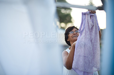 Buy stock photo Wet, laundry and senior woman with washing line in backyard for hanging, clothes or drying outdoor. Fabric, cleaning and elderly female person with housework, routine and textile sanitation outside