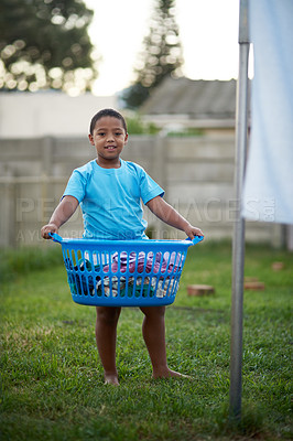 Buy stock photo Boy, kid and outdoor with basket or laundry for growth, child development and learning. Parent, Portrait, kid and smile at home with washing or clothes for childhood memories, fun and house activity
